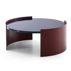 The Bowy coffee tables by Patricia Urquila for Cassina have a sleek, round design with simple minimalist lines. They come in two different finishes: a glossy lacquered finish reminiscent of the 1970s or a more rustic, textured wooden top.