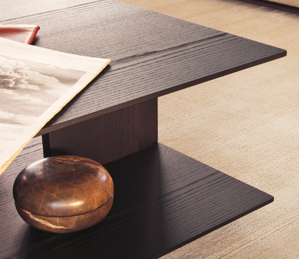 The Westside Coffee Table, designed by Jean-Marie Massaud for Poliform, is a masterful blend of materials and shapes. The unique base detail design allows for a half-peek through effect, creating an interesting visual appeal and providing a space for decor items to be displayed. Shown here in timber finish.