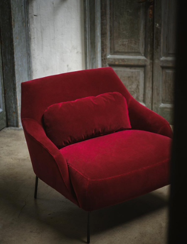 The sensual and sensational Lima armchair by Swedish designers, Claesson Koivisto Rune, weds ergonomic pleasure with a deep, inviting, and outlandishly comfortable seat thanks to the additional back cushion. Shown here in a deep red velvet fabric.